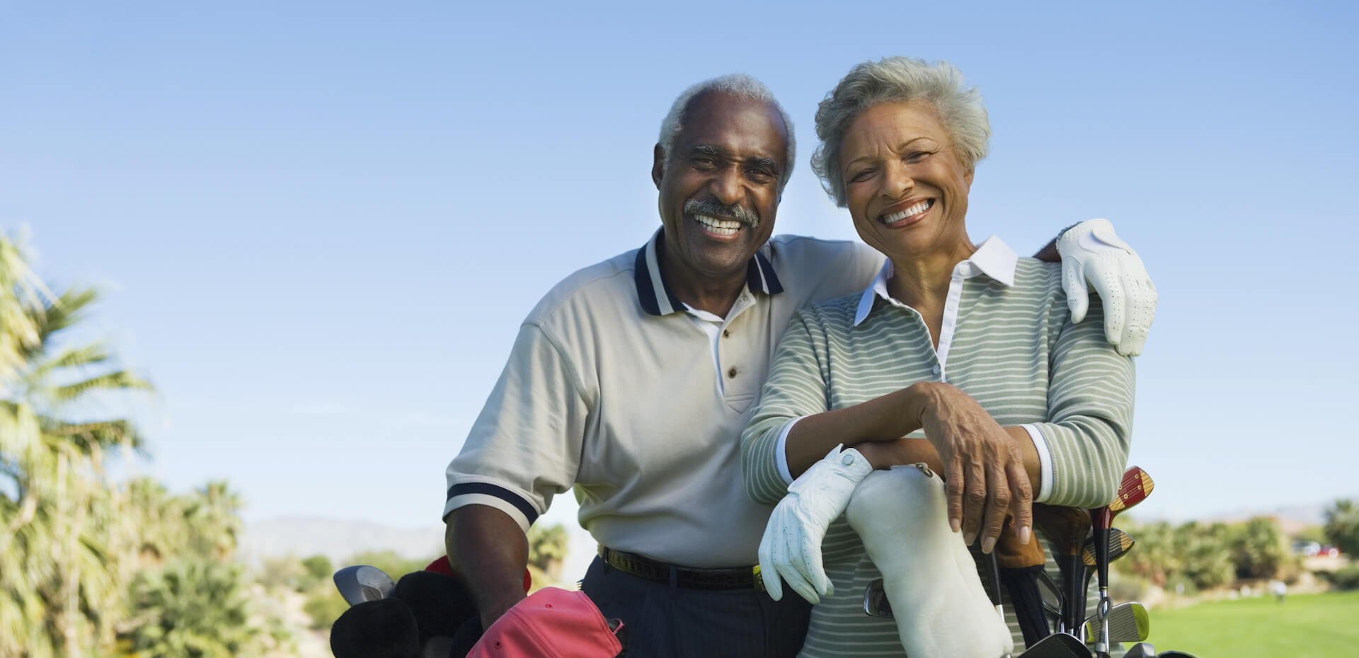 African American couple golfing in the eligible age for cataract surgery