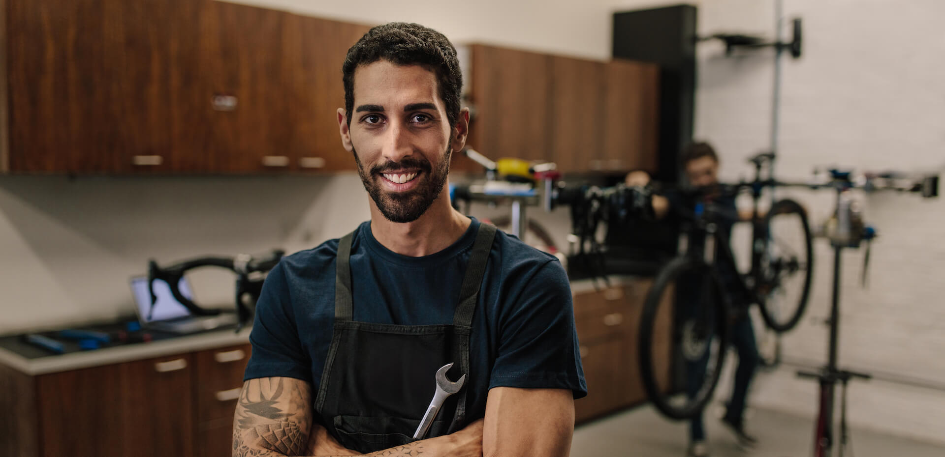 Bicycle repair man in shop to show how ICL eye surgery may benefit freedom from glasses or contact lenses.