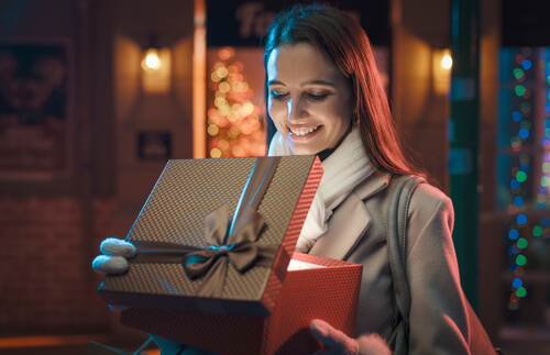 Happy woman opening gift
