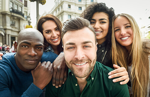 Group of young, multi-ethnic friends smiling at camera