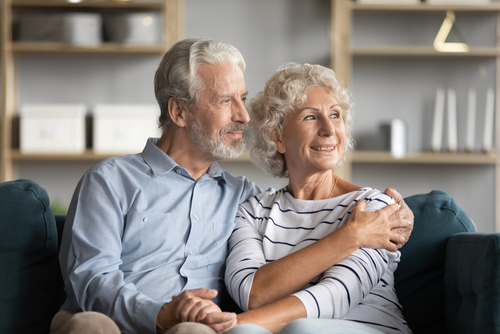 Elderly couple sitting on a couch together